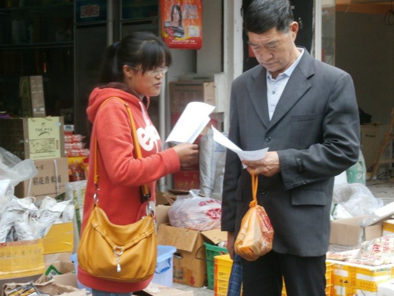 同学向路人发放法律知识宣传单 同学向路人发放法律知识宣传单